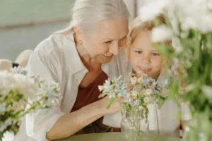 Grandmother admires flowers with grandchild